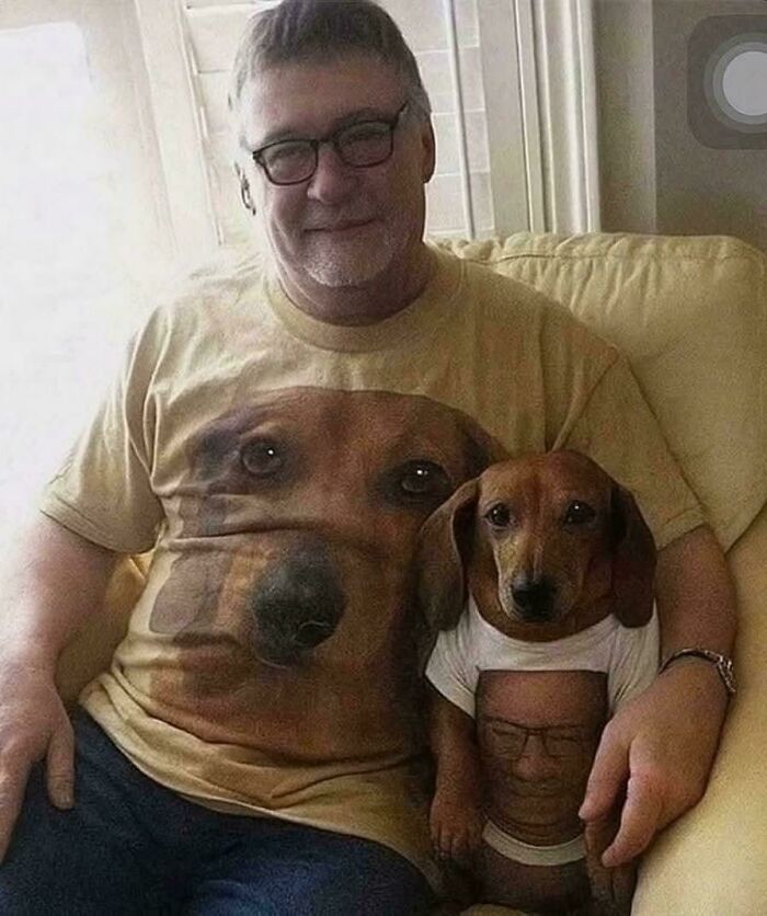 Man and dog wearing matching shirts with each other's faces, a humorous image that goes hard and makes people chuckle.