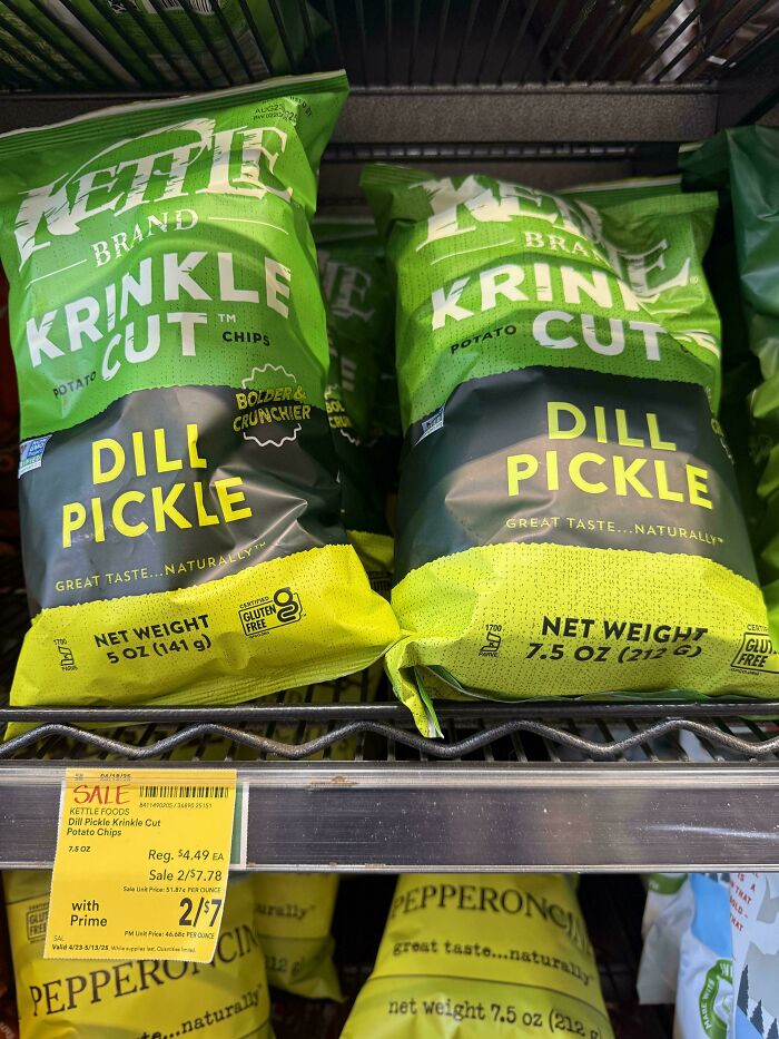 Bags of dill pickle flavored potato chips showing different package sizes on a store shelf highlighting sneakflation.