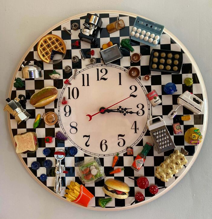 Clock with miniature kitchen and food items on a checkerboard background, a unique thrift store jackpot find.