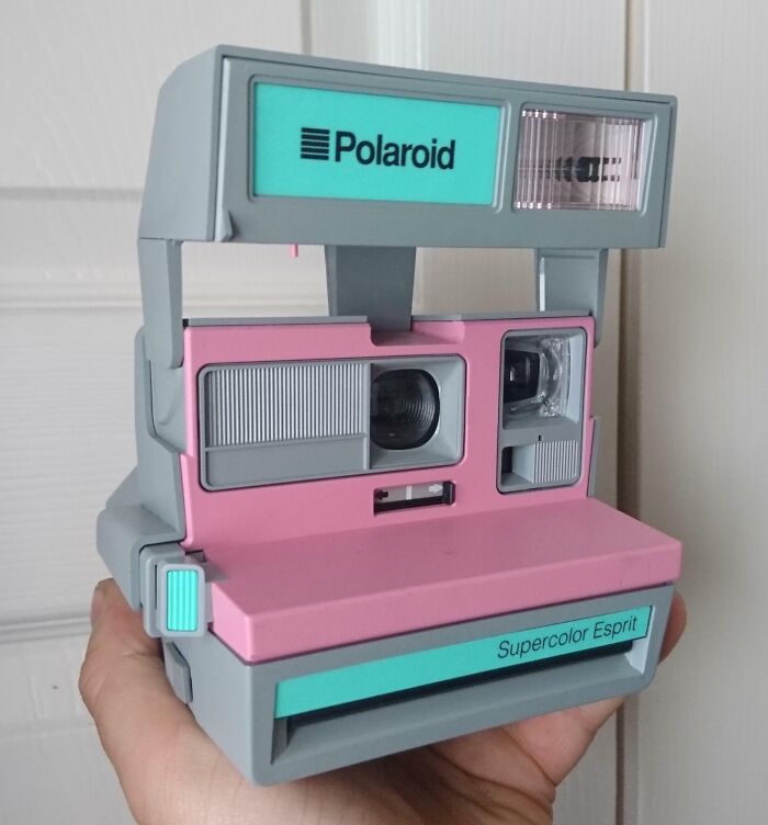 Vintage Polaroid Supercolor Esprit camera held in hand, a lucky thrift store jackpot find by shoppers.