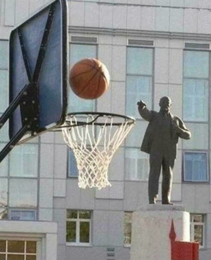 Basketball hoop and ball appearing to go through a statue with people chuckling at these pictures that go hard.