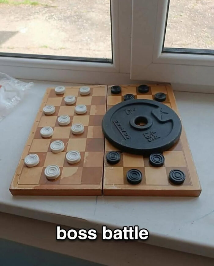 Checkers game with a heavy weight plate on one side in a humorous picture that goes hard and makes people chuckle.