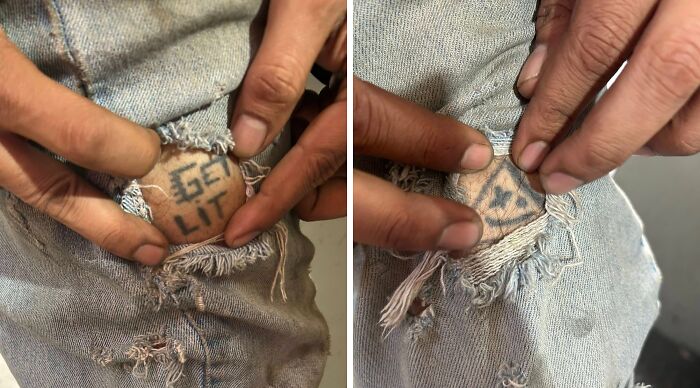 Close-up of hands pulling torn jeans revealing unusual tattoos beneath the fabric on a person's leg.