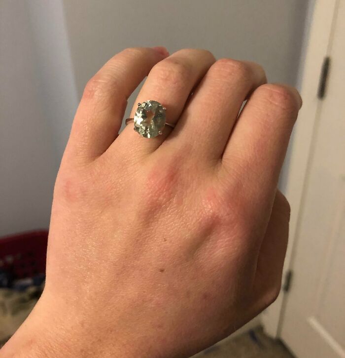 Close-up of a hand wearing a sparkling gemstone ring, showcasing a lucky thrift store jackpot find.