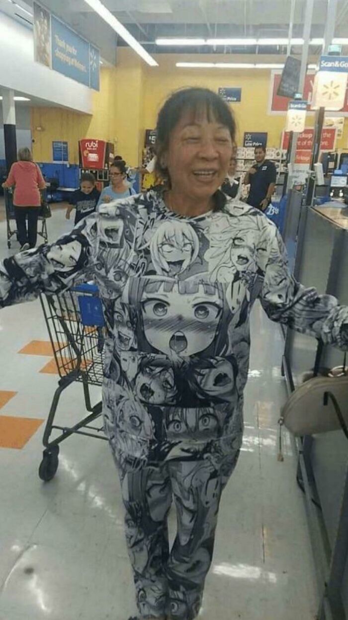 Older woman wearing a full anime print outfit inside Walmart, surrounded by shoppers and shopping carts.