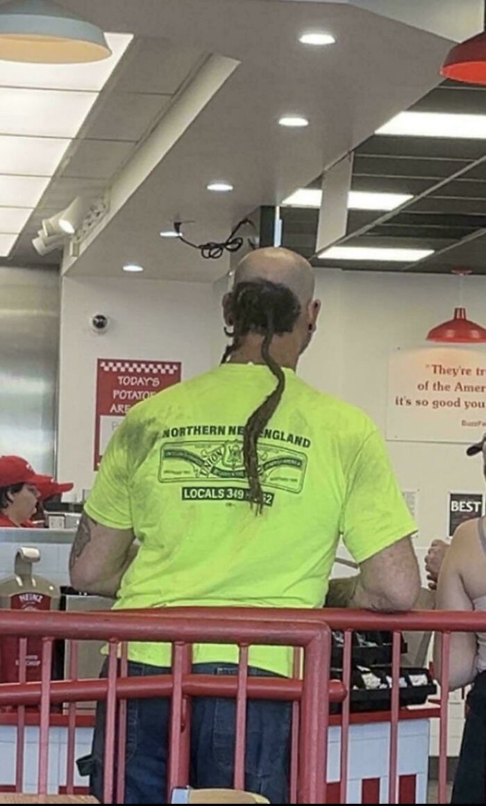 Man with unusual dreadlock hairstyle standing in line, showcasing one of the wildest People of Walmart moments.