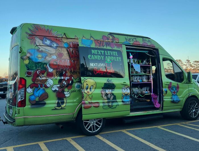 Colorful van decorated with cartoon characters selling candy apples in a Walmart parking lot, showcasing unique People Of Walmart style.