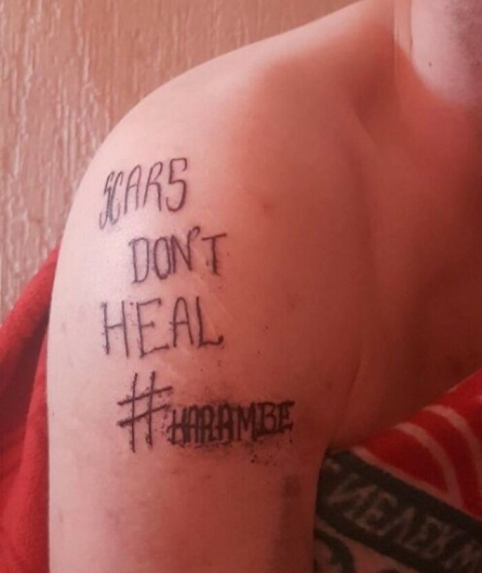 Tattoo fail on shoulder with poorly done text and hashtag, an example of epic tattoo fails shared online.