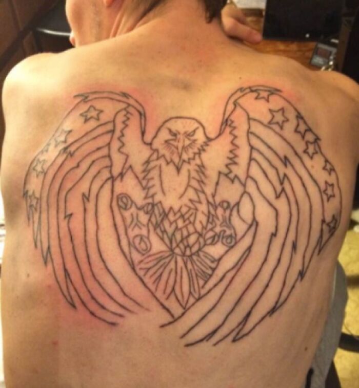 Large back tattoo with an eagle and hand design showing clear signs of a tattoo fail shared online.