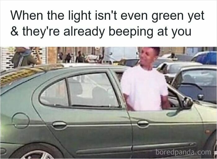 Man leaning out of car window looking confused, illustrating road rage in hilarious driving meme about impatience at traffic lights.