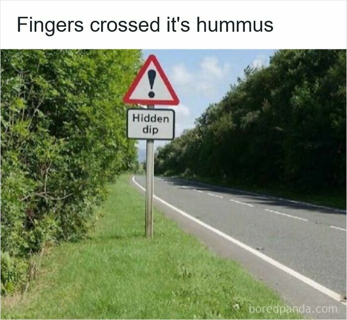 Road sign warning about a hidden dip on a rural road, featured in funny driving memes about road rage.