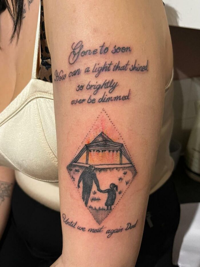 Memorial tattoo with text and a diamond-shaped design of a person holding a child's hand, an example of tattoo fails.