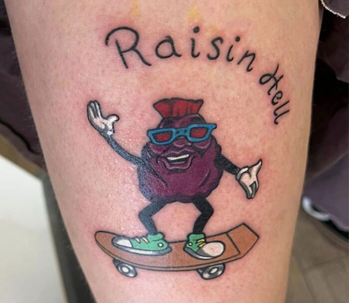 Tattoo fail of a raisin character on a skateboard with misspelled text on a person's leg, showcasing epic tattoo mistakes.
