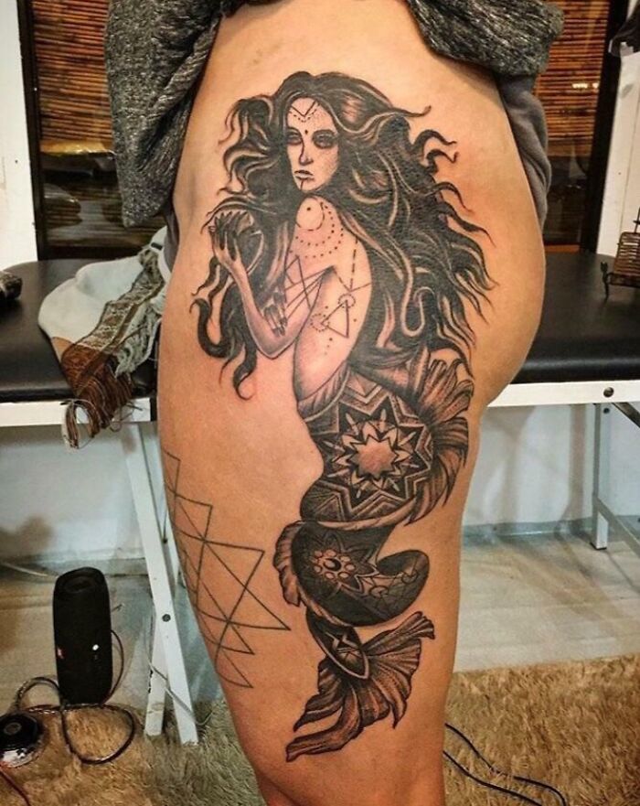 Large black and grey mermaid tattoo on thigh showing detailed patterns, an example of epic tattoo fails shared online.