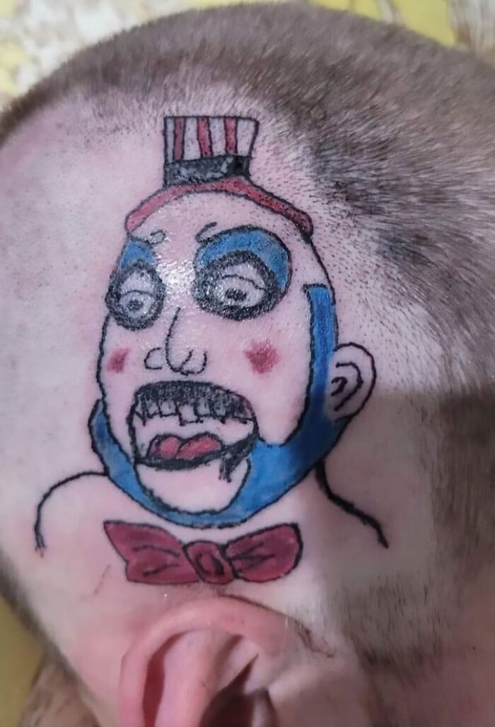 Close-up of a colorful clown tattoo on a person's head showcasing one of the most epic tattoo fails shared online.