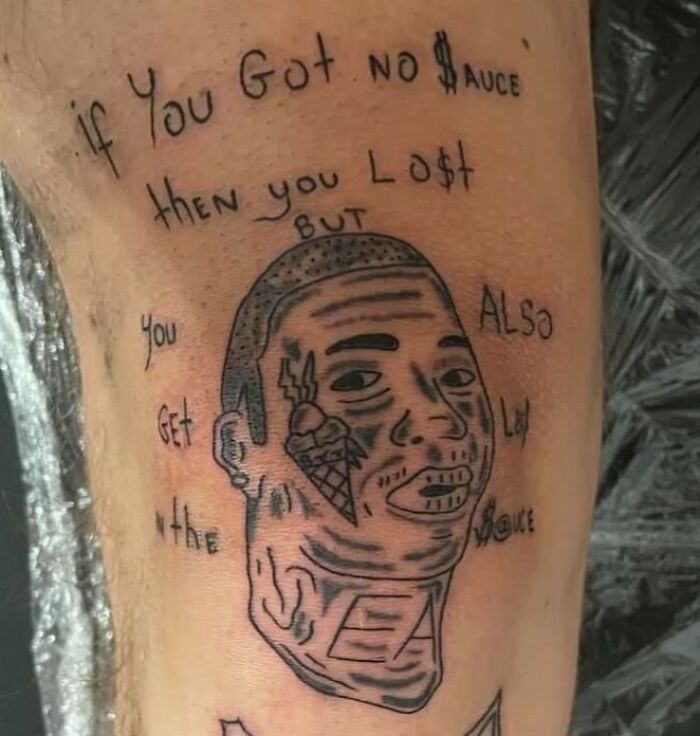 Tattoo fail showing poorly drawn face with a misspelled motivational quote on skin, an epic example of tattoo fails.