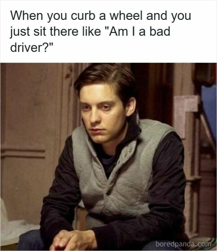 Young man looking worried reflecting on curbing a wheel, a relatable moment in driving memes about road rage frustration.