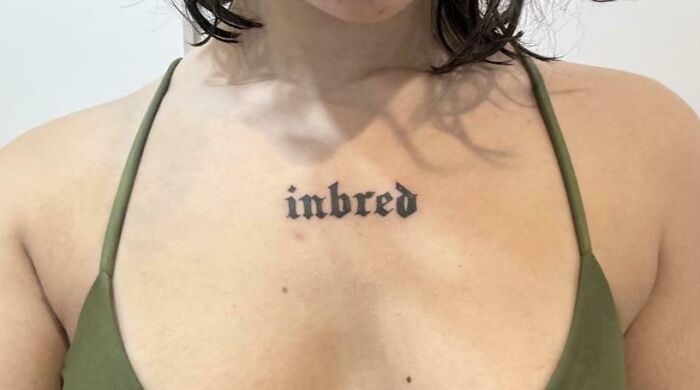 Close-up of a chest tattoo fail with the word inbred, showcasing one of the most epic tattoo fails shared online.