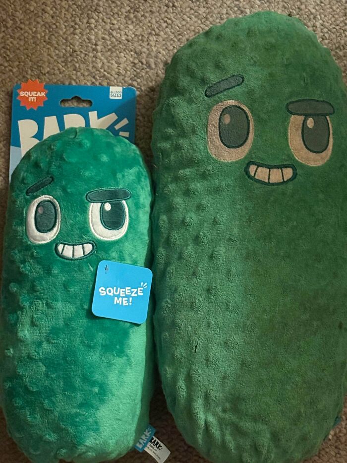 Two green plush pickle toys with faces highlighting examples of sneakflation through size differences in products.