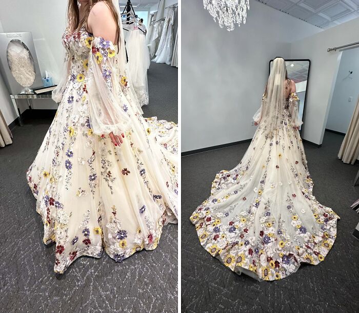 Woman wearing a flowing floral dress with cottage core aesthetics details in a bridal fitting room with chandelier lighting