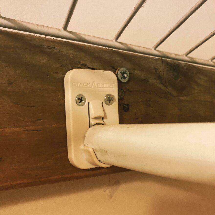 Close-up of a broken stack shelf bracket still holding a rod, showing people knew what they were doing and still went for it.
