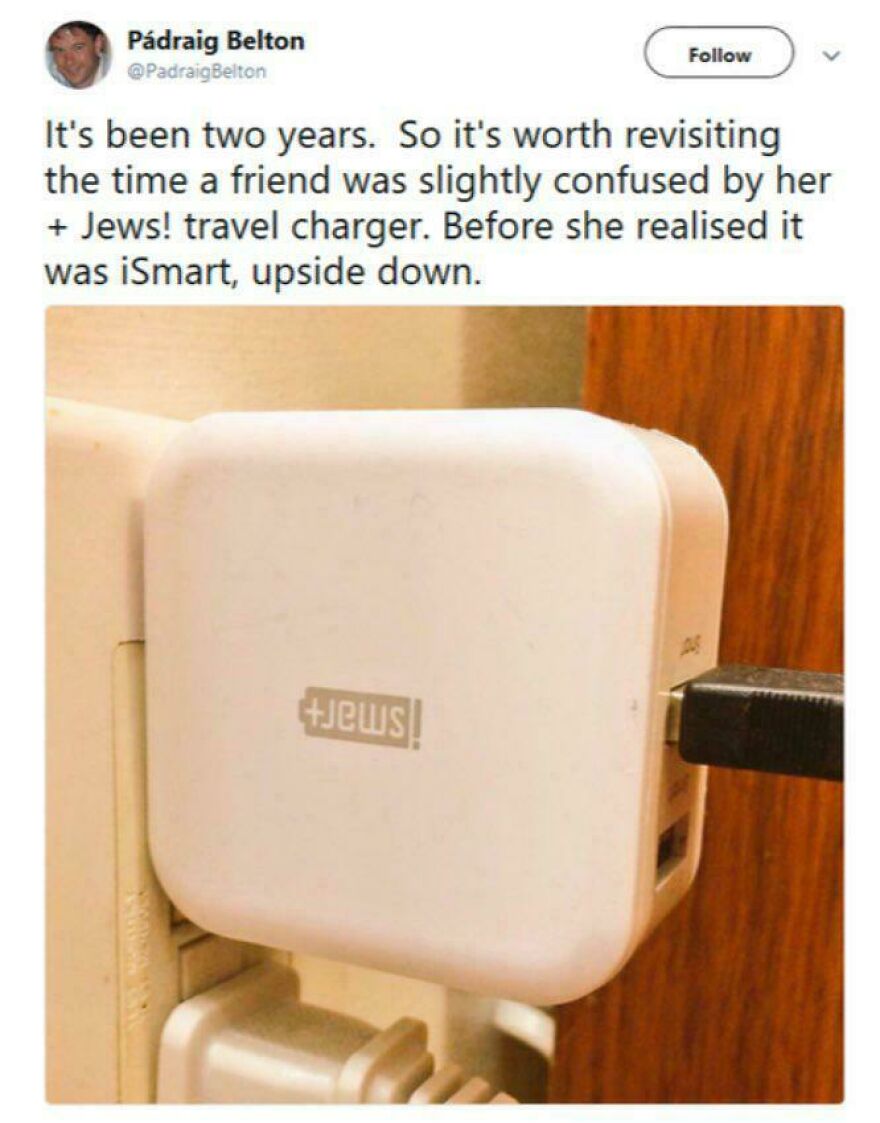 Travel charger plugged in upside down, showing a funny moment of people knowing what they were doing and still going for it.