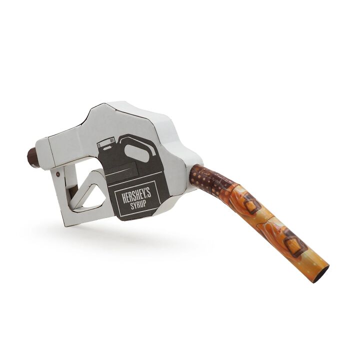 Fuel pump nozzle art piece repurposing waste materials, reflecting witty commentary on modern life and consumer culture.