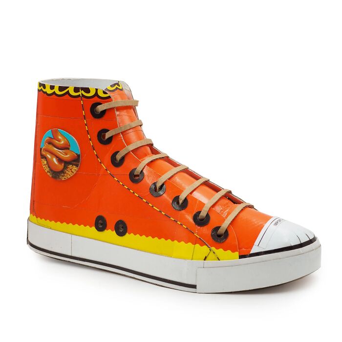 Artistic sneaker sculpture made from waste materials, showcasing witty commentary on modern life through creative reuse.