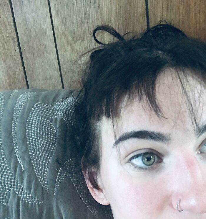 Close-up of a person with messy dark hair and uneven bangs, showcasing a hilariously tragic hair accident moment.