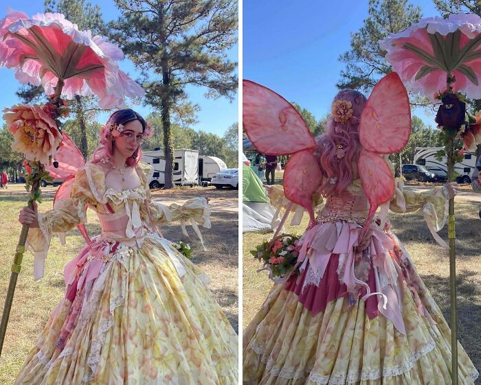 Person in whimsical cottage core aesthetics dress with floral umbrella and butterfly wings outdoors on a sunny day