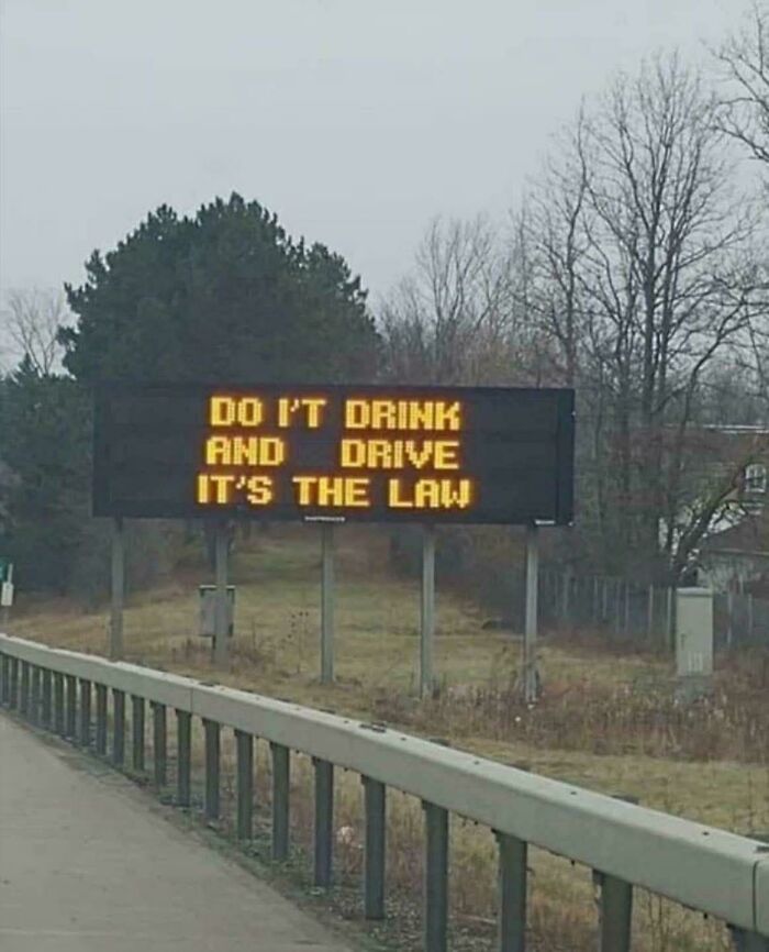 LED sign on roadside with a humorous message about drink and driving displaying bright amber text outdoors.
