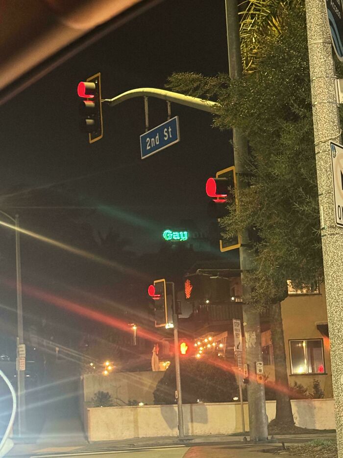 Night street scene with illuminated LED signs including a 2nd St traffic light and a glowing green LED sign reading Gray.