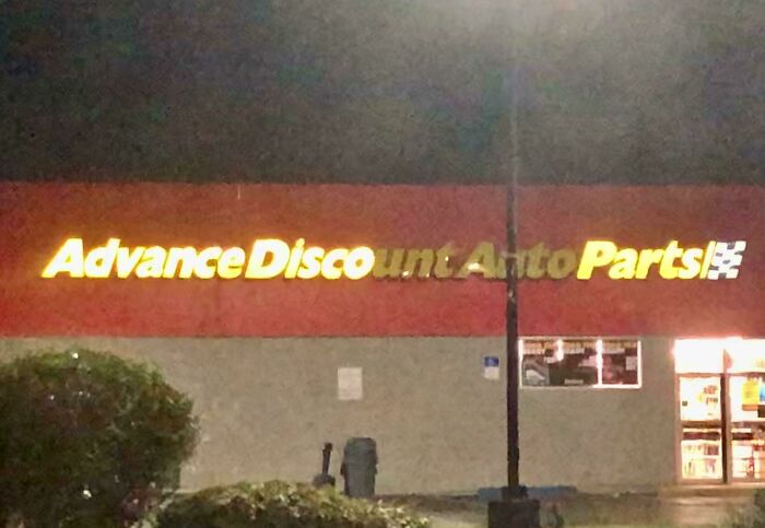 LED sign for Advance Discount Auto Parts store at night, with some letters partially unlit and hard to read.