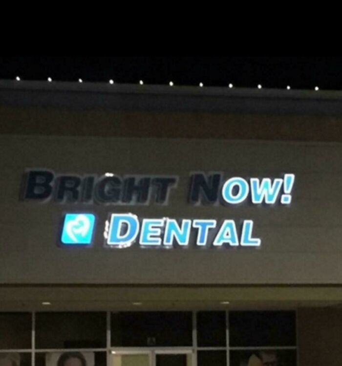 LED sign for Bright Now Dental glowing at night on a building exterior with a blue and white color scheme.