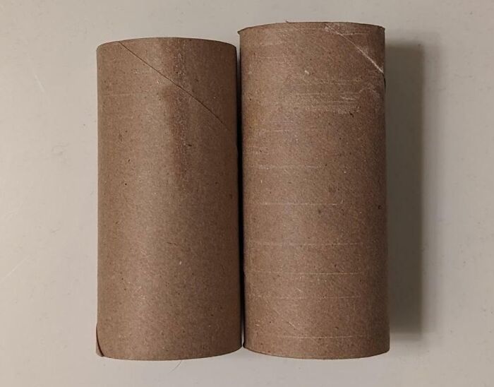 Two empty cardboard toilet paper rolls side by side representing sneakflation and reduced product size.