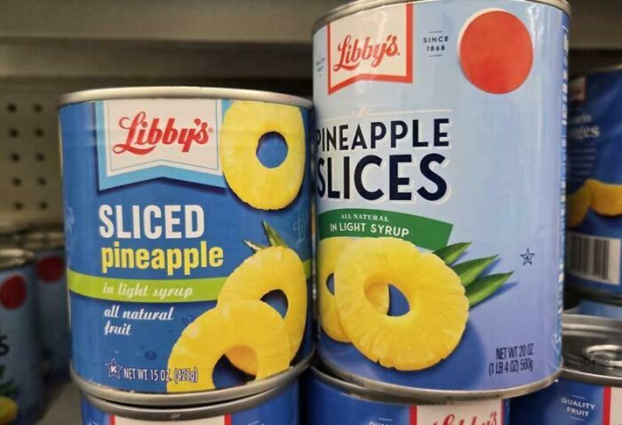 Canned Libby’s sliced pineapple on store shelves, illustrating examples of sneakflation in everyday grocery items.