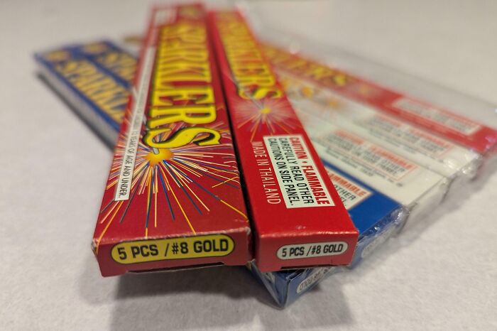 Boxes of sparklers arranged on a surface, illustrating examples of sneakflation in everyday product packaging.
