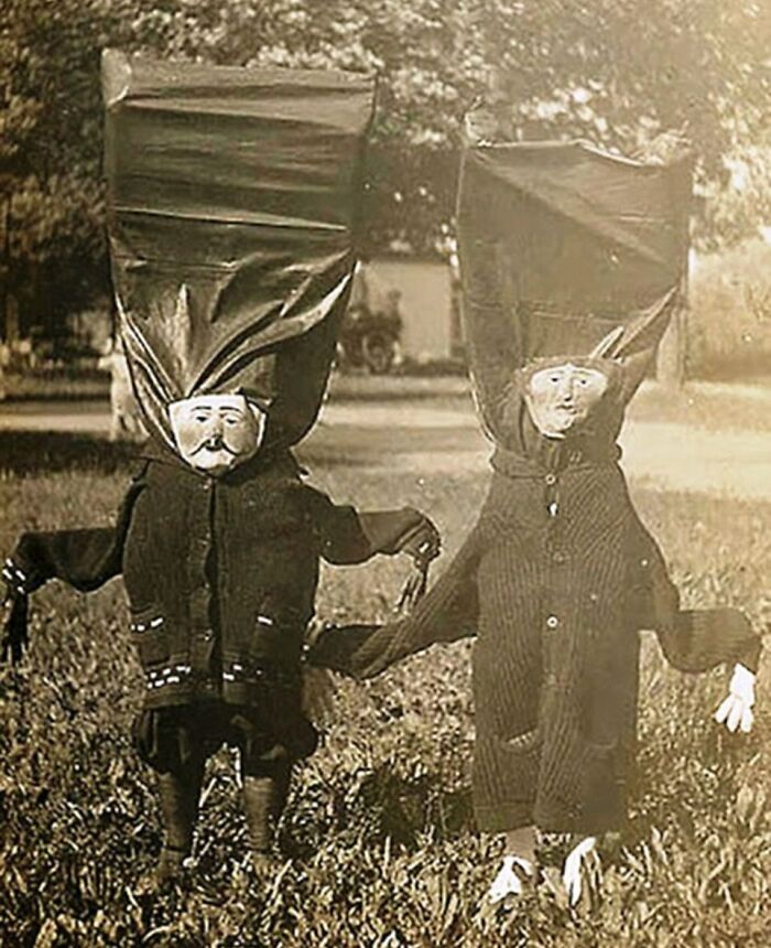 Vintage Halloween costumes from the past featuring eerie and impressive designs with large headpieces and old-fashioned masks.