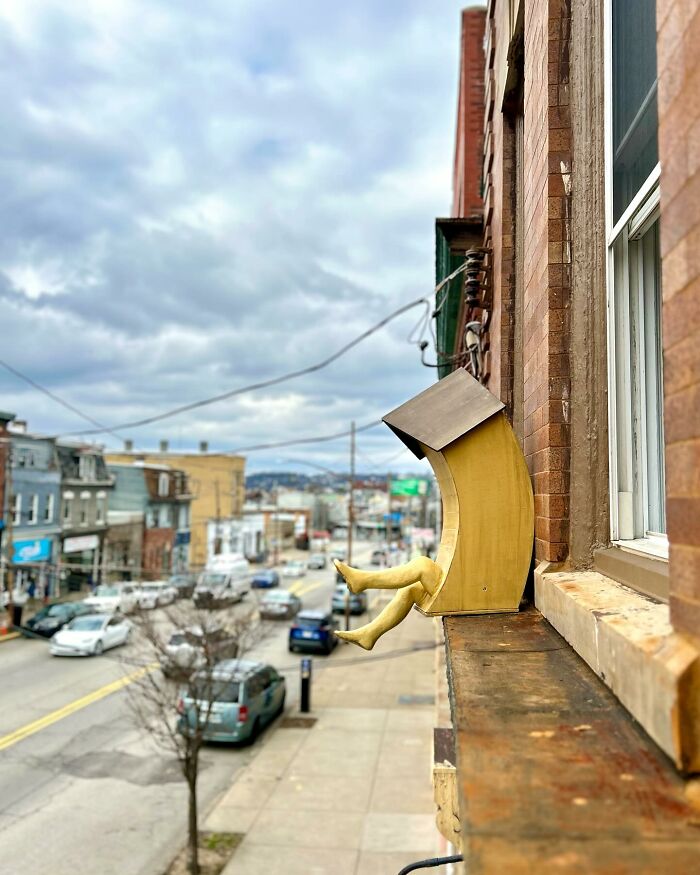 Surreal collage of a building with human legs walking out, blending architecture with movement on a city street.
