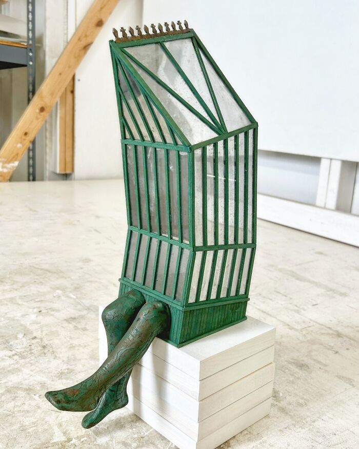 Surreal collage art of a building with walking legs, blending architecture and human form in an imaginative sculpture.