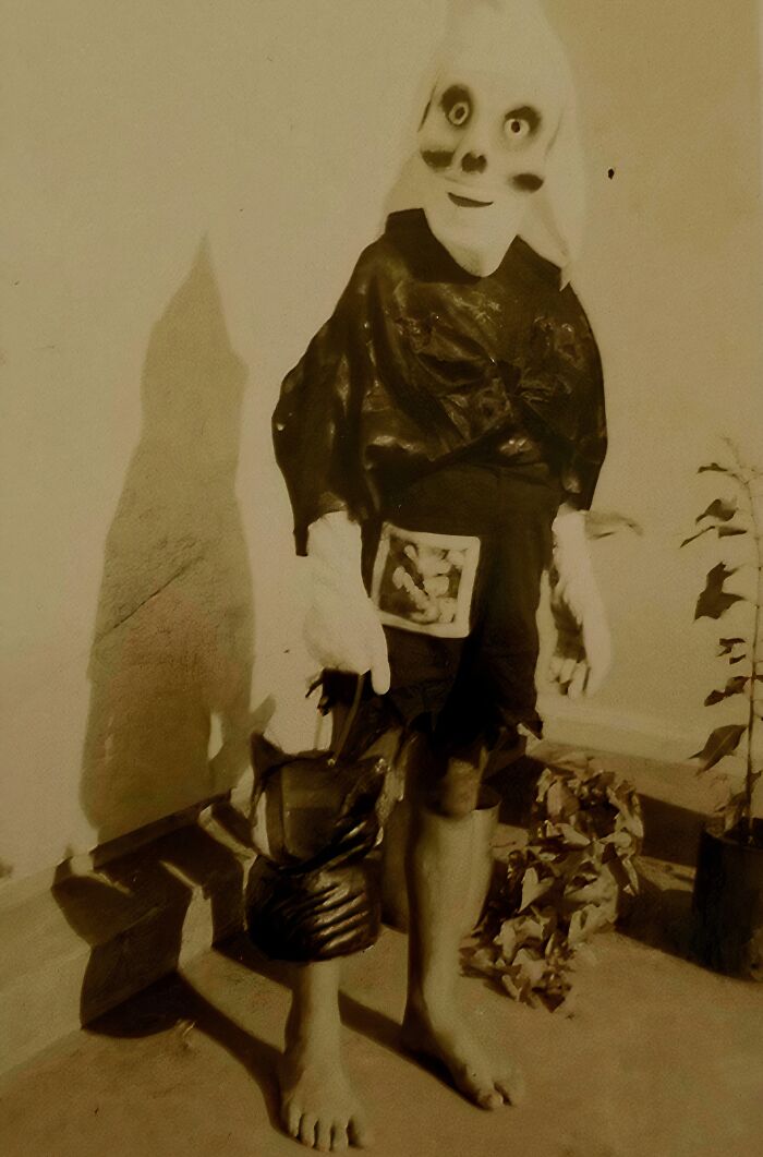Vintage Halloween costume featuring a creepy and impressive mask and outfit from past decades.