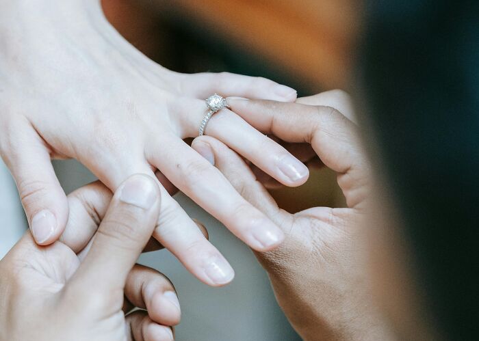 Close-up of hands showing a diamond ring, symbolizing dramatic breakup stories and chaotic relationship moments.