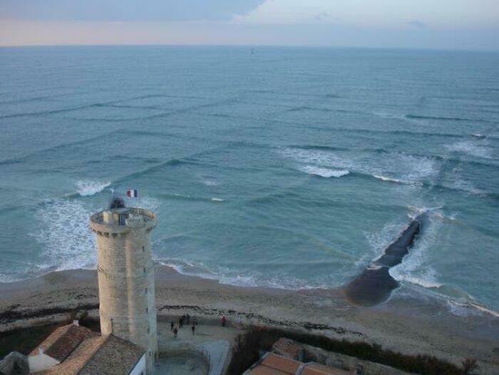 Aerial view of a coastal tower by the ocean, showcasing interesting pics that answer unexpected questions.