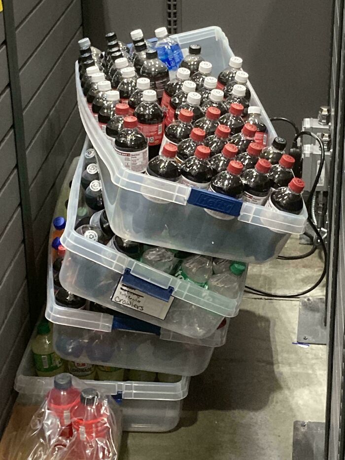 Plastic containers stacked precariously with soda bottles inside, moments before disaster struck in a hilarious photo.