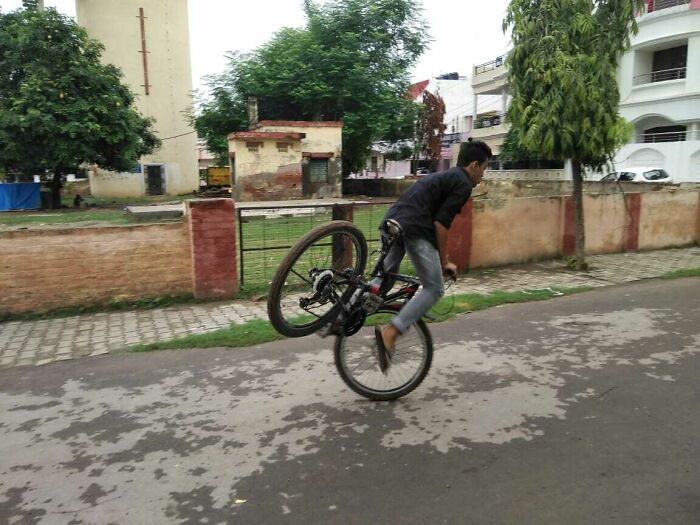 Young man attempting bike stunt on street moments before disaster in hilarious photos people managed to take before disaster struck