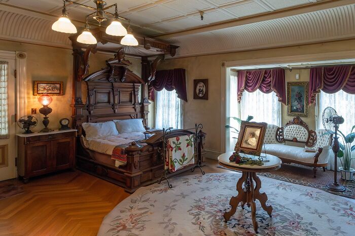 Victorian bedroom with antique wooden bed and vintage furniture in one of the spooky destinations for Halloween visitors.