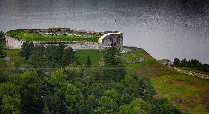 Historic fort surrounded by water and dense forest, a spooky destination perfect for Halloween exploration and haunting adventure.