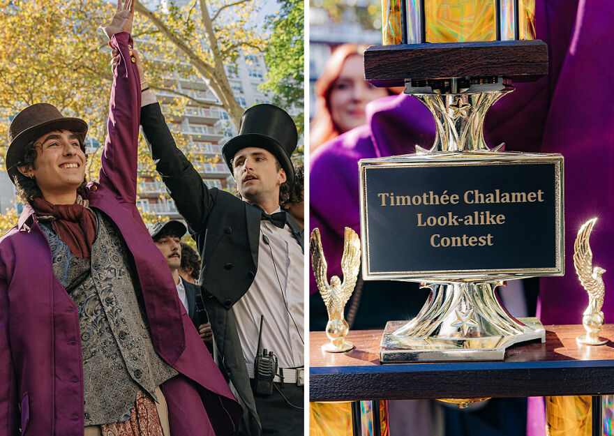 Two men in costumes high-fiving outside near a trophy for a Timothée Chalamet look-alike contest, pop culture event.