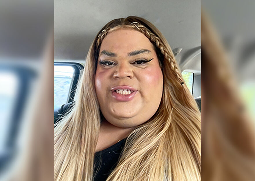 Person with long blonde hair and braided accents taking a selfie inside a car, related to 2024 pop culture moments.