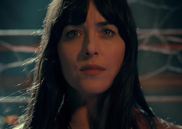 Close-up of a woman with dark hair and green eyes looking surprised, representing 2024 pop culture moments that caught off guard.